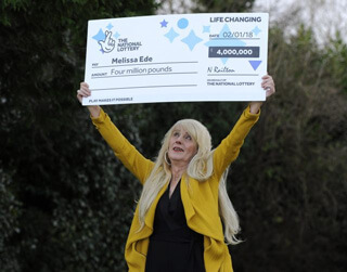 Melissa with big check above her head